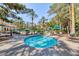 Community hot tub surrounded by palm trees and patio furniture at 270 E Flamingo Rd # 223, Las Vegas, NV 89169