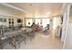 Open-concept living and dining area with neutral decor and large mirrored wall reflecting natural light throughout at 270 E Flamingo Rd # 223, Las Vegas, NV 89169