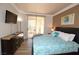 Cozy bedroom with a mounted TV and sliding glass door leading to a balcony at 270 E Flamingo Rd # 223, Las Vegas, NV 89169