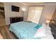 This main bedroom comes complete with TV, dresser and natural light at 270 E Flamingo Rd # 223, Las Vegas, NV 89169