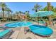Inviting pool with lounge chairs, umbrellas, and mature landscaping for relaxing outdoors at 270 E Flamingo Rd # 223, Las Vegas, NV 89169