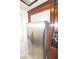 Stainless steel refrigerator stands ready in this kitchen with dark wood trim and cabinets at 270 E Flamingo Rd # 223, Las Vegas, NV 89169