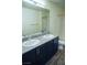 Modern bathroom featuring double vanity with granite countertops, bathtub and vinyl floors at 2761 Frosted Teal Ave, North Las Vegas, NV 89086