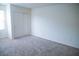 Neutral bedroom with carpet flooring, closet with double doors, and a window with blinds at 2761 Frosted Teal Ave, North Las Vegas, NV 89086