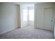 Carpeted bedroom with a double door closet and three windows at 2761 Frosted Teal Ave, North Las Vegas, NV 89086