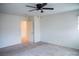Spacious bedroom with carpet, ceiling fan, neutral walls, and access to an adjoining room at 2761 Frosted Teal Ave, North Las Vegas, NV 89086