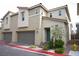 Two-story townhome with attached garage and desert landscaping, showcasing modern design at 2761 Frosted Teal Ave, North Las Vegas, NV 89086