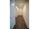 Hallway with wood-look floors leading to a white front door and staircase at 2761 Frosted Teal Ave, North Las Vegas, NV 89086