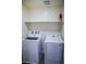 Laundry room featuring a new washer, dryer, shelf, and an easily accessible fire extinguisher at 2761 Frosted Teal Ave, North Las Vegas, NV 89086