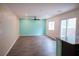 Bright living room with hardwood floors, fan, and sliding glass doors leading to the outdoor area at 2761 Frosted Teal Ave, North Las Vegas, NV 89086