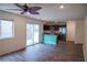 Open-concept living area with modern kitchen, stainless steel appliances, and access to patio at 2761 Frosted Teal Ave, North Las Vegas, NV 89086