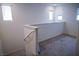 Cozy loft area with carpet and railing, lit by natural light at 2761 Frosted Teal Ave, North Las Vegas, NV 89086
