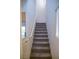 Carpeted staircase ascends to the second level with natural light from a window at 2761 Frosted Teal Ave, North Las Vegas, NV 89086