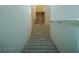 Carpeted stairs leading down with handrail, light walls, and open bathroom door at 2761 Frosted Teal Ave, North Las Vegas, NV 89086