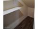 Attic storage area with white shelving and wood-look flooring at 2761 Frosted Teal Ave, North Las Vegas, NV 89086