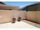 Cozy back patio with a white fence, pebble landscaping, flamingo decorations, and a covered pergola at 2840 China Cove St, Laughlin, NV 89029