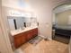 Bright bathroom with a dual sink vanity and tile floors, conveniently located near the bedroom at 2840 China Cove St, Laughlin, NV 89029