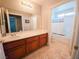 Bright bathroom with a single sink vanity, tile floors, and a shower/tub combination at 2840 China Cove St, Laughlin, NV 89029