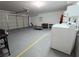Spacious two car garage featuring washer, dryer and some fitness equipment at 2840 China Cove St, Laughlin, NV 89029
