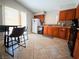 Spacious kitchen with tile flooring, wooden cabinetry, and a functional layout at 2840 China Cove St, Laughlin, NV 89029