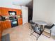 Eat-in kitchen features ample cabinet space, a cozy dining table, and tile flooring at 2840 China Cove St, Laughlin, NV 89029