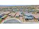 Aerial view of a single story home with solar panels, landscaping, and brick paver driveway at 2910 Monate Ct, Henderson, NV 89044
