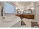 The bathroom has dual sinks, a soaking tub, and wood cabinetry at 2910 Monate Ct, Henderson, NV 89044