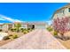 Charming single story home with desert landscaping, stone accents, and a brick paver driveway at 2910 Monate Ct, Henderson, NV 89044