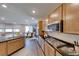 Modern kitchen featuring an island and views into the living and dining area at 2910 Monate Ct, Henderson, NV 89044