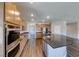 Bright kitchen with a large island, stainless steel appliances, wood cabinets, and wood floors at 2910 Monate Ct, Henderson, NV 89044