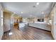 Open-concept living area with wood floors, media wall, kitchen access and access to the patio at 2910 Monate Ct, Henderson, NV 89044