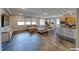 Open-concept living room with hardwood floors and large windows at 2910 Monate Ct, Henderson, NV 89044