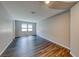 Living room boasting hardwood floors, neutral walls and natural light from two large windows at 2910 Monate Ct, Henderson, NV 89044