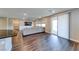 Open-concept living area with wood floors, access to the kitchen, media wall, sofa and access to the patio at 2910 Monate Ct, Henderson, NV 89044