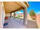 Covered patio with paved brick flooring, outdoor seating, and a landscaped backyard view at 2910 Monate Ct, Henderson, NV 89044