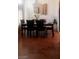 Sun-filled dining room with modern chandelier and sleek hardwood floors at 3301 W Colton Ave, North Las Vegas, NV 89032
