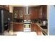 Well-equipped kitchen with stainless steel appliances, wooden cabinets, and tile backsplash at 3301 W Colton Ave, North Las Vegas, NV 89032
