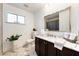 Clean bathroom featuring a marble vanity, a large mirror, and modern fixtures at 3481 Winery Rd, Pahrump, NV 89048