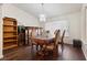Well-lit dining room with wood floors, dining table set, and decorative shelving at 3481 Winery Rd, Pahrump, NV 89048