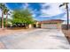 Inviting single-story home with a spacious driveway, two-car garage, and well-maintained desert landscaping at 3481 Winery Rd, Pahrump, NV 89048