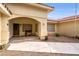 Charming front entrance with an arched alcove, a bench, and a well-maintained walkway at 3481 Winery Rd, Pahrump, NV 89048