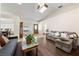 Cozy living room featuring wood flooring, a comfortable sectional sofa, and a skylight above at 3481 Winery Rd, Pahrump, NV 89048