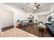 Inviting living room with a cozy fireplace, wood floors, ceiling fan, and comfortable seating at 3481 Winery Rd, Pahrump, NV 89048