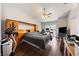 Bright main bedroom with a ceiling fan, wood-look flooring, and a large bed, with a desk area at 3481 Winery Rd, Pahrump, NV 89048