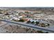 A street view showing well-kept homes in a desert-like suburban neighborhood, under a clear sky at 3481 Winery Rd, Pahrump, NV 89048