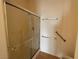Bathroom shower with glass doors and grab bars at 3508 Kittiwake Rd, North Las Vegas, NV 89084