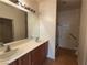 Bathroom with double vanity, large mirror, and walk-in shower with safety bars at 3508 Kittiwake Rd, North Las Vegas, NV 89084
