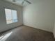 Bedroom with neutral carpet, ceiling fan, and window providing natural light at 3508 Kittiwake Rd, North Las Vegas, NV 89084