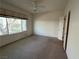 Bedroom with neutral carpet, a window view, and a ceiling fan at 3508 Kittiwake Rd, North Las Vegas, NV 89084