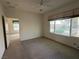 Bright bedroom features a ceiling fan and a view of outside greenery from the window at 3508 Kittiwake Rd, North Las Vegas, NV 89084